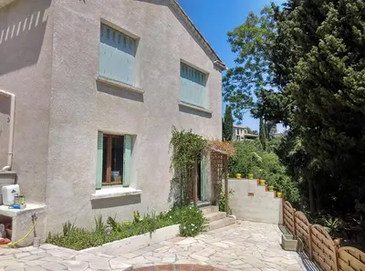 a house with a stone walkway in front of it at Gîte avec vue imprenable sur la Cité in Carcassonne