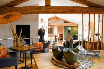 a living room with a lot of furniture at L'Autre Jardin, centre historique, calme, garage gratuit in Mirepoix