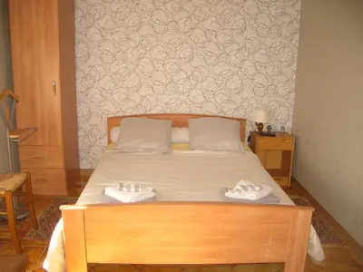 a bedroom with a bed with two towels on it at Charmante chambre d'hôte in Sigean