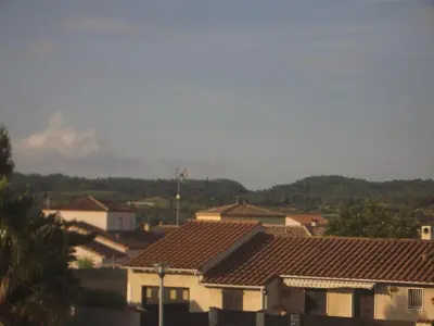 a view of roofs of houses in a town at Charmante chambre d'hôte in Sigean