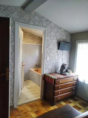 a bathroom with a sink and a door to a tub at Charmante chambre d'hôte in Sigean