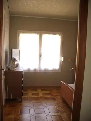 a room with a window and a teddy bear on a dresser at Charmante chambre d'hôte in Sigean