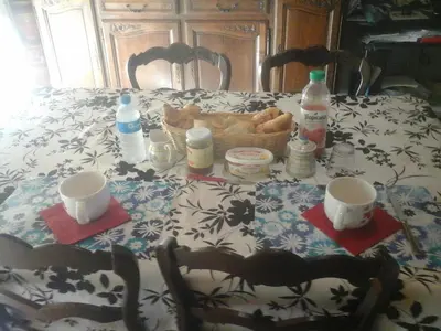 a table with a table cloth with a basket of food at Charmante chambre d'hôte in Sigean