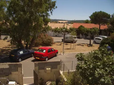 a group of cars parked in a parking lot at Charmante chambre d'hôte in Sigean