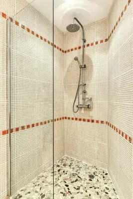 a shower with a glass door in a bathroom at Domaine de Parazols in Fabrezan