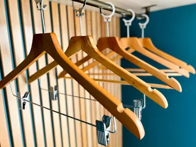 a group of wooden hangers hanging from a staircase at The Originals City, Hôtel Le Puech, Narbonne in Narbonne