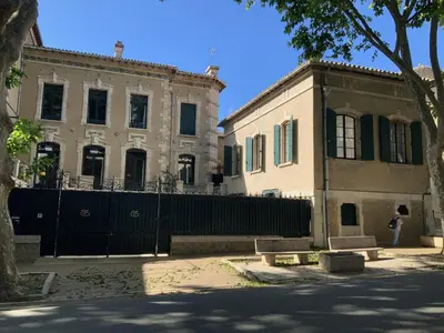 a person standing in front of a building at Château Tallavignes in Fabrezan