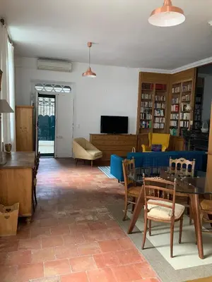 a living room with a table and chairs at Château Tallavignes in Fabrezan
