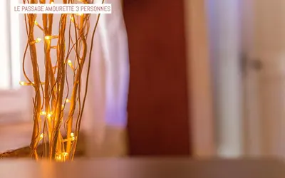 a vase filled with lights sitting on a table at Le Passage in Carcassonne