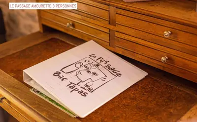 a book sitting on top of a wooden dresser at Le Passage in Carcassonne