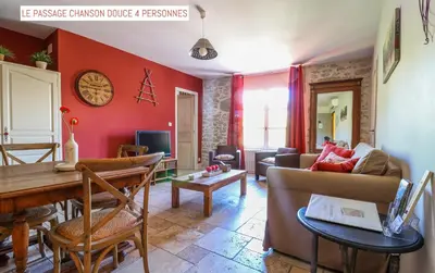 a living room with a couch and a table at Le Passage in Carcassonne