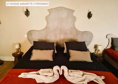 a bedroom with a bed with towels on it at Le Passage in Carcassonne
