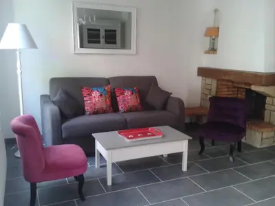 a living room with a couch and a table at Chez Clémentine in Montolieu
