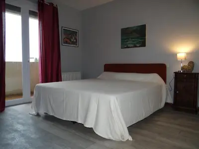 a bedroom with a white bed and a window at 37 au soleil in Montréal