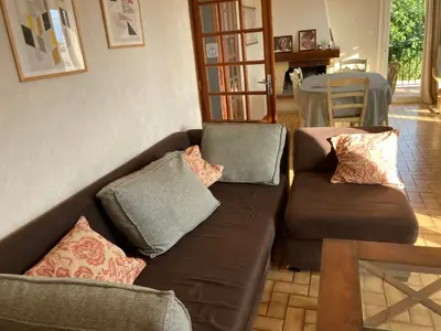 a living room with a brown couch and a table at 37 au soleil in Montréal