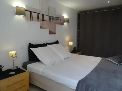 a bedroom with a large bed with white sheets at 37 au soleil in Montréal