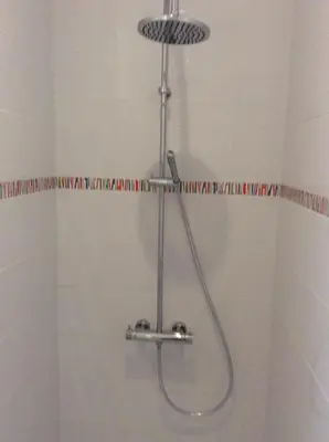 a shower with a shower head in a bathroom at villa du chai studio pyrénées in Lézignan-Corbières