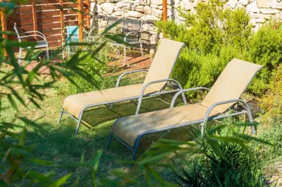 two chairs sitting in the grass in a yard at La Barbacane in Sigean