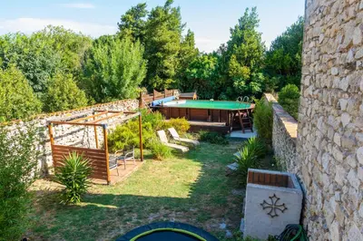 an external view of a garden with a pool at La Barbacane in Sigean
