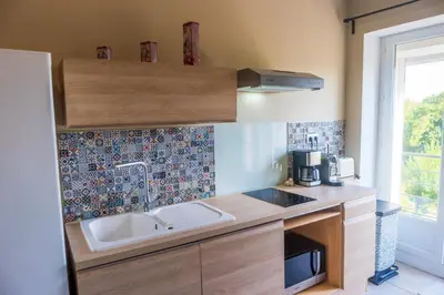 a kitchen with a sink and a counter top at La Barbacane in Sigean