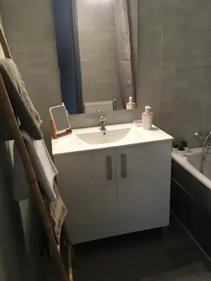 a bathroom with a white sink and a bath tub at Marina in Narbonne