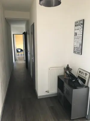 a hallway of a room with white walls and wooden floors at Marina in Narbonne