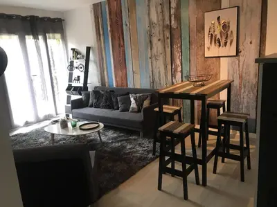 a living room with a couch and a table at Marina in Narbonne