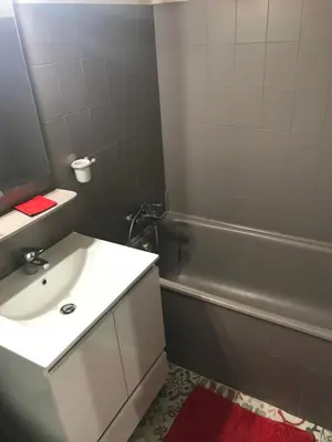 a bathroom with a white sink and a bath tub at Marina in Narbonne