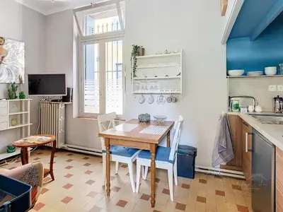 a kitchen with a table and chairs and a sink at Apartment Jeanne in Carcassonne