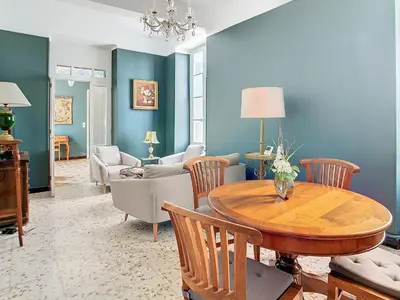 a living room with a table and chairs at Apartment Le Jardin in Carcassonne