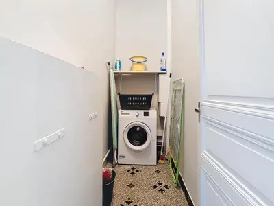 a small laundry room with a washing machine in it at Apartment Le Jardin in Carcassonne