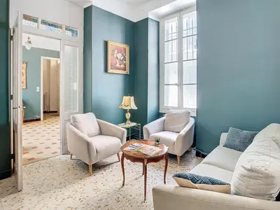 a living room with a couch and two chairs and a table at Apartment Le Jardin in Carcassonne