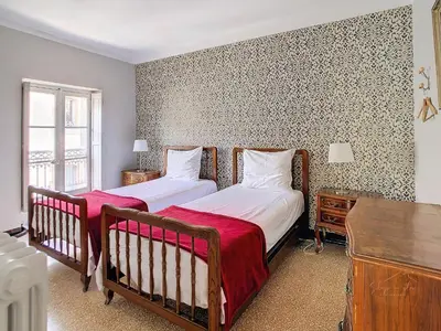 a bedroom with two beds and a window at Apartment Carcasses in Carcassonne
