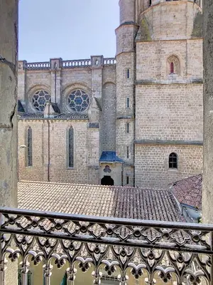 a large brick building with a gate in front of it at Apartment Carcasses in Carcassonne