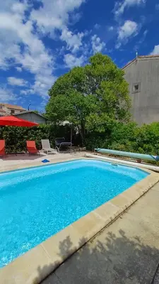 a large blue swimming pool in a yard at Canta aoussel in Moussoulens