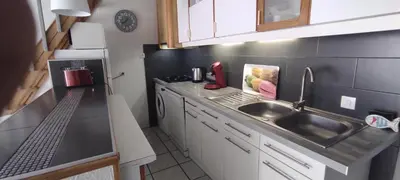 a small kitchen with a sink and a counter at Gites Vert à la mer climatisation dans toutes les pièces in Port-la-Nouvelle