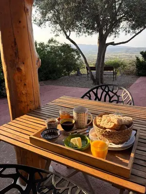 a wooden table with a tray of food on it at Yourte Mongole Insolite - Gîte Saint Roch in Tuchan