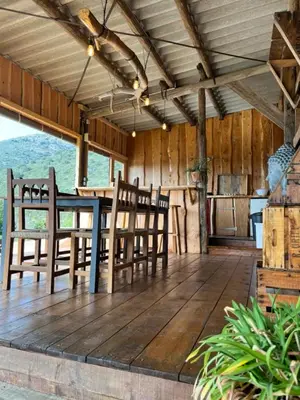 a porch with chairs and a table and a kitchen at Yourte Mongole Insolite - Gîte Saint Roch in Tuchan