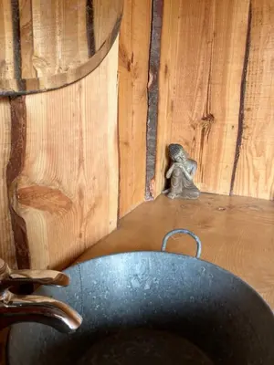 a small figurine sitting next to a wooden wall at Yourte Mongole Insolite - Gîte Saint Roch in Tuchan