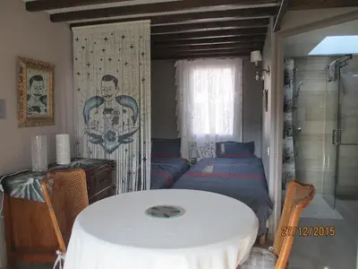 a room with a table and a bed in it at Maison TOMAS in Pomas