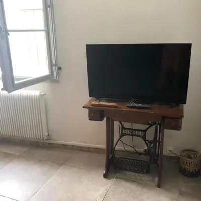 a flat screen tv sitting on a table in a room at Coté remparts in Carcassonne