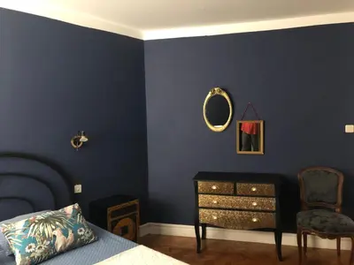a bedroom with a bed and a dresser and a mirror at Coté remparts in Carcassonne