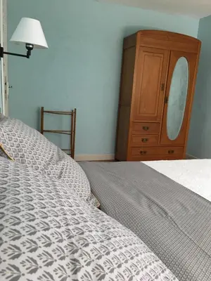 a bedroom with a bed and a wooden dresser at Coté remparts in Carcassonne