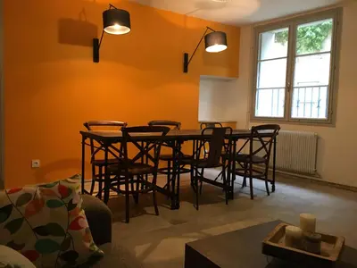 a living room with a dining room table and chairs at Coté remparts in Carcassonne