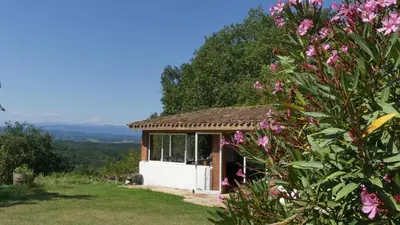 a small house in a field with pink flowers at Belrepayre in Manses