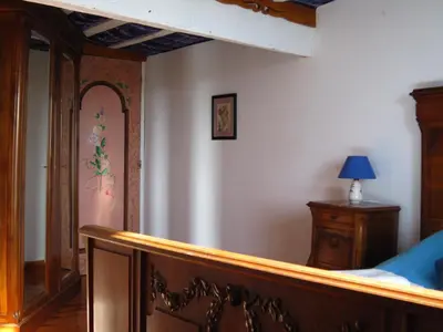 a bedroom with a bed and a dresser and a mirror at Belrepayre in Manses