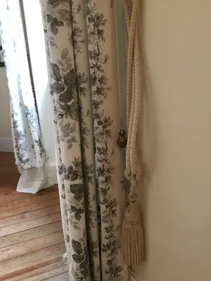 a curtain hanging on a wall next to a window at les camélias in Mazamet