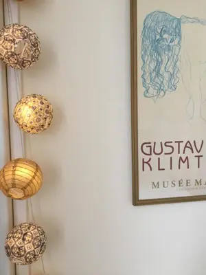 a wall with three chandeliers and a picture at les camélias in Mazamet