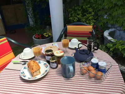 a table with food and eggs and drinks on it at les camélias in Mazamet