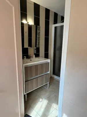 a bathroom with a sink and a mirror at Hôtel Restaurant Les Arcades in Limoux